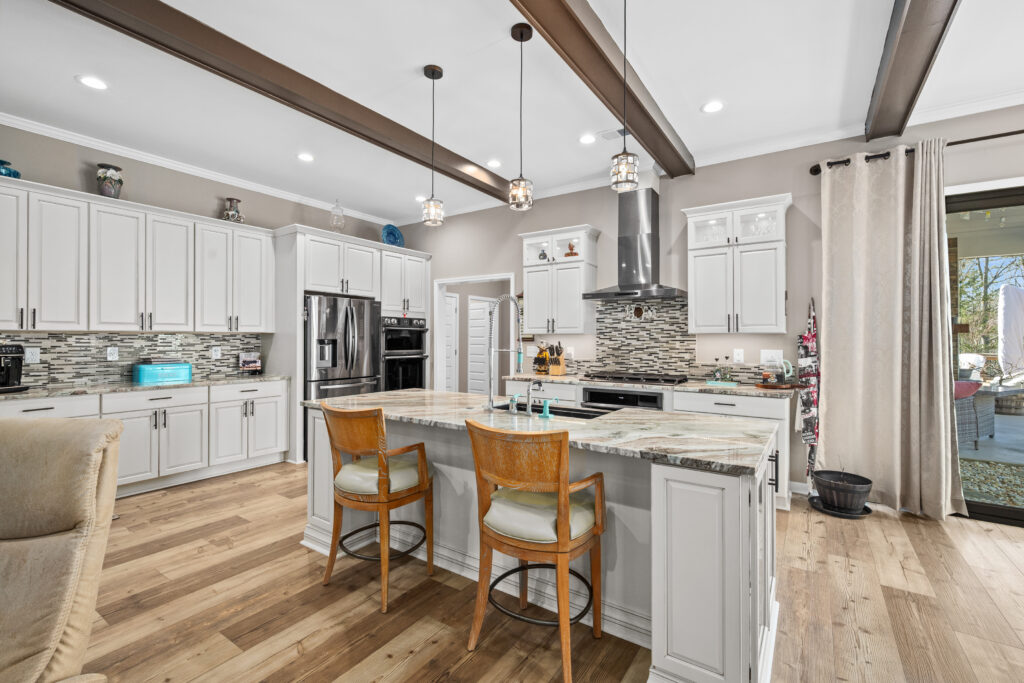 Kitchen at 106 Osage Ct Lake Arrowhead in Waleska GA with oversized island, double ovens, and custom cabinetry